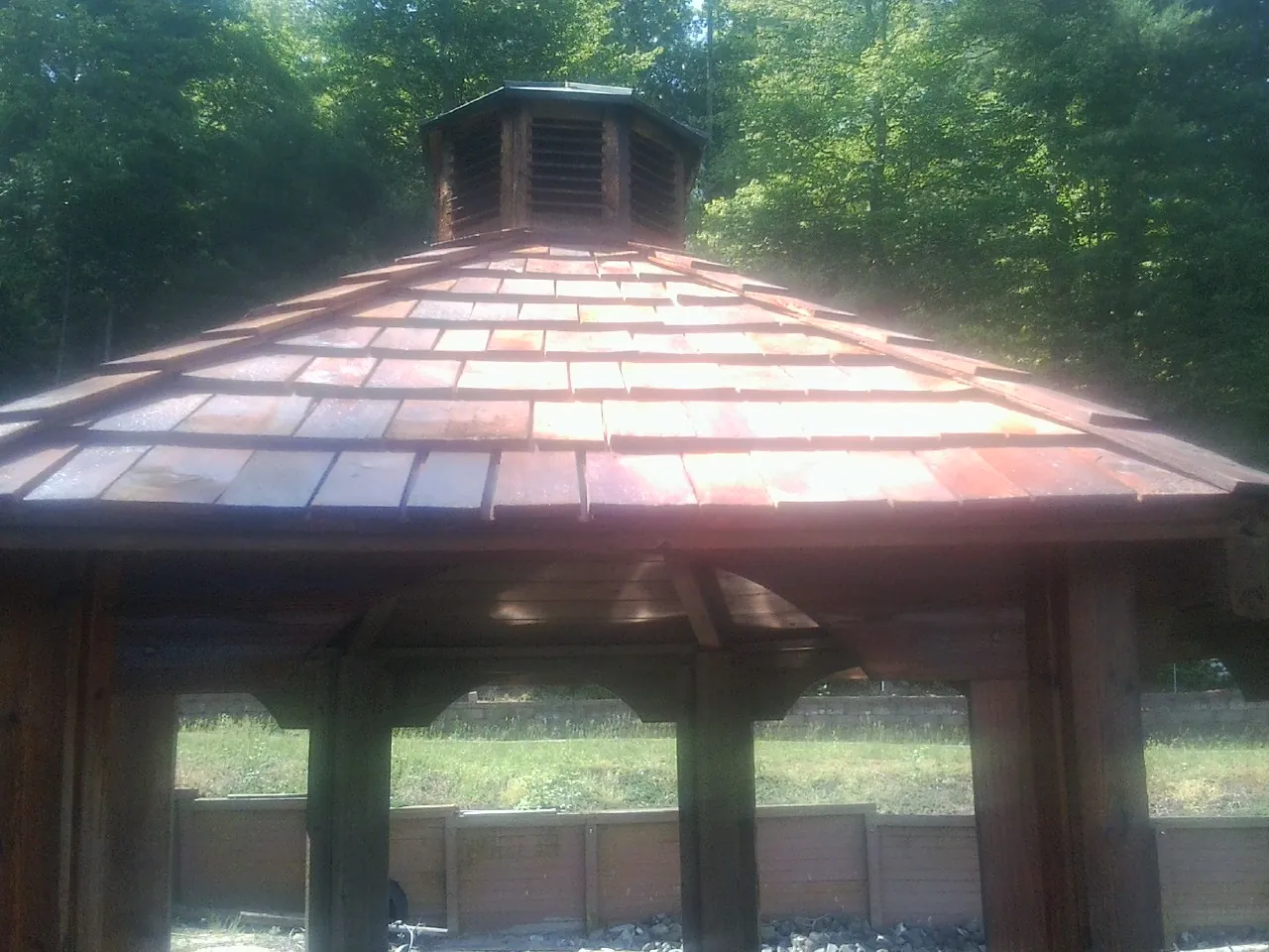 New cedar shake roof and cupola on a lakeside gazebo in Westcliffe